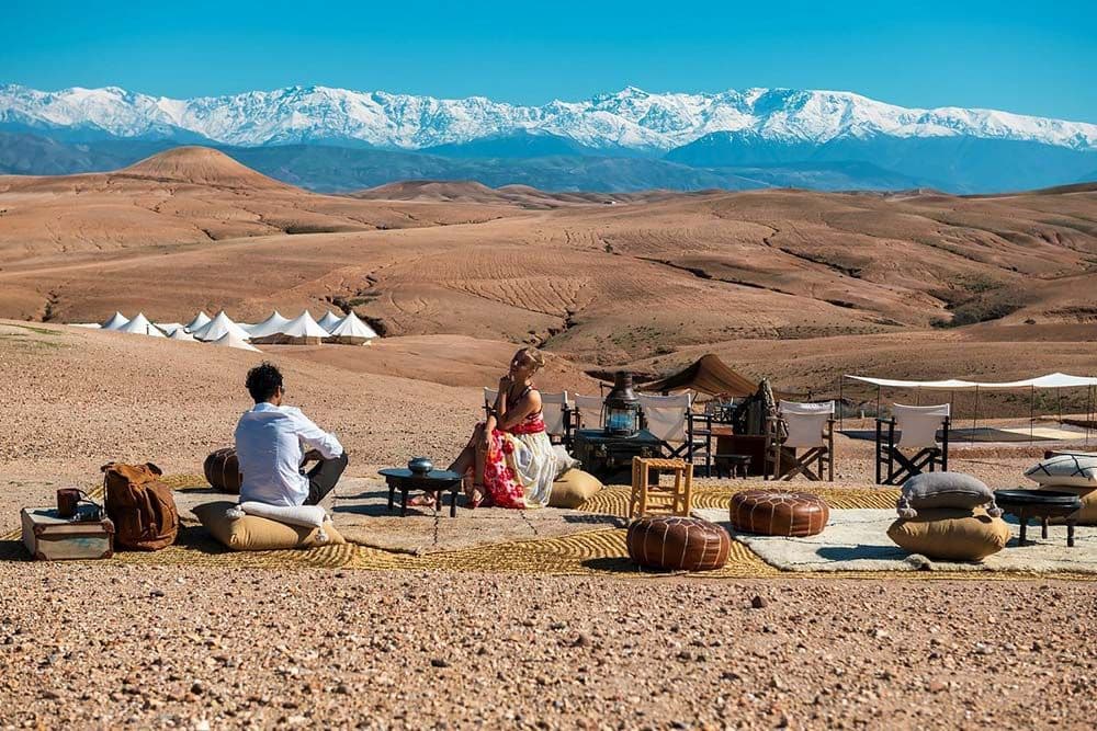 A desert camp in Agafay facing the snow-capped Atlas